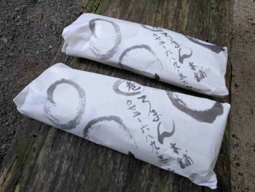 紙に包まれた巻きずし2本